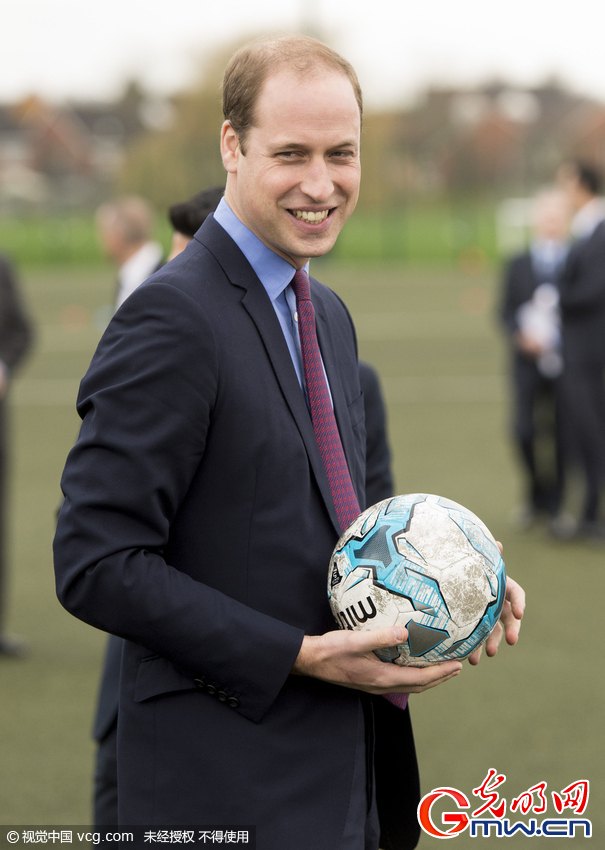 威廉王子造访英国伯明翰 西装革履踢球耍帅