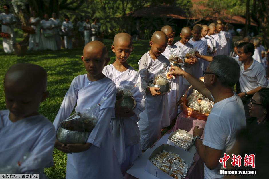 泰国迎宋干节 小比丘尼跟师傅身后化斋萌萌哒